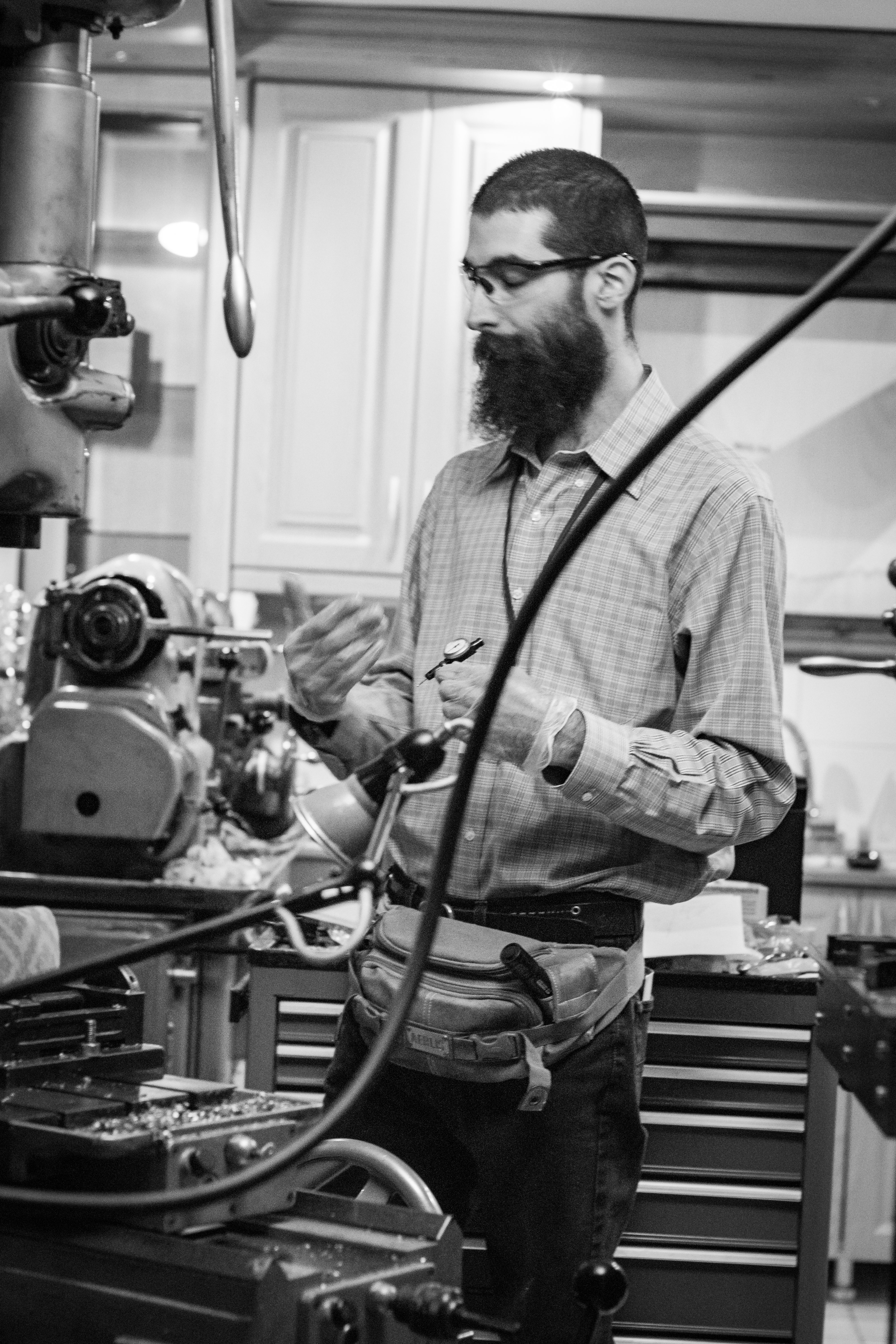 J. I. Agnew in the workshop with a Moore Jig Borer in the foreground and a Hardinge HLV lathe in the background.